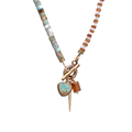 necklace featuring a striking combination of brass-edged Turquoise, Hessonite, and Moonstone beads, with a brass toggle clasp and a 14K gold-plated brass spike charm.