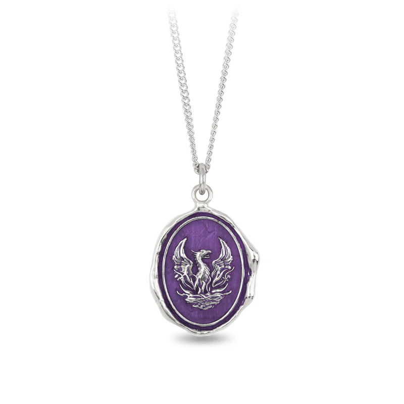 Sterling Silver Necklace with a violet background under a talisman depicting The mythological creature the Phoenix