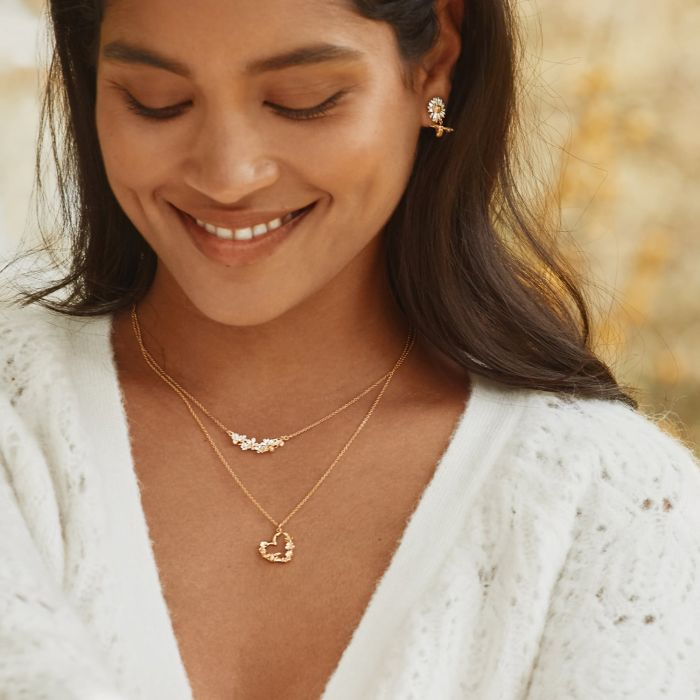 Gold Plated silver necklace with a heart pendant arranged with gold flowers | On model
