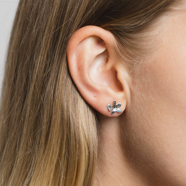 Sterling silver small flower studs with sterling silver posts  | on model
