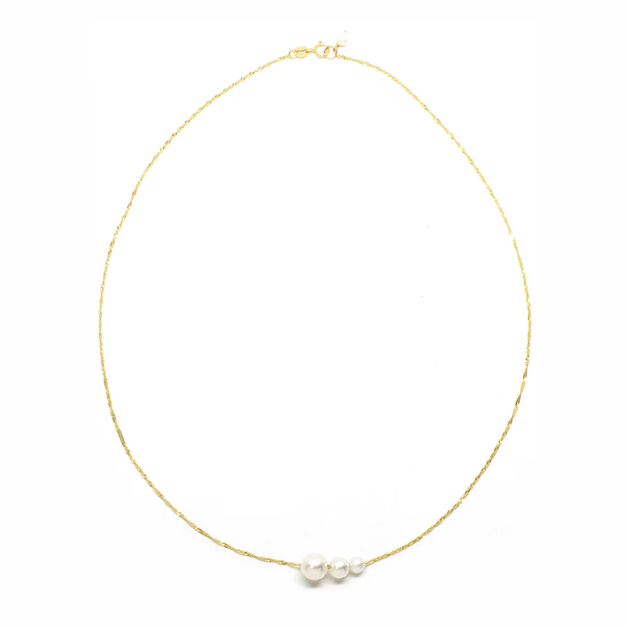 Handcrafted from 14k-karat gold, this delicate necklace is anchored with three luminous pearls in gradual sizes