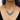Plated Sterling Silver Necklace Featuring an Intricate Design with mixes of multicoloured Textile thread and multiple sizes of gemstones and beads. The main colours include tones of blue and green. | on model