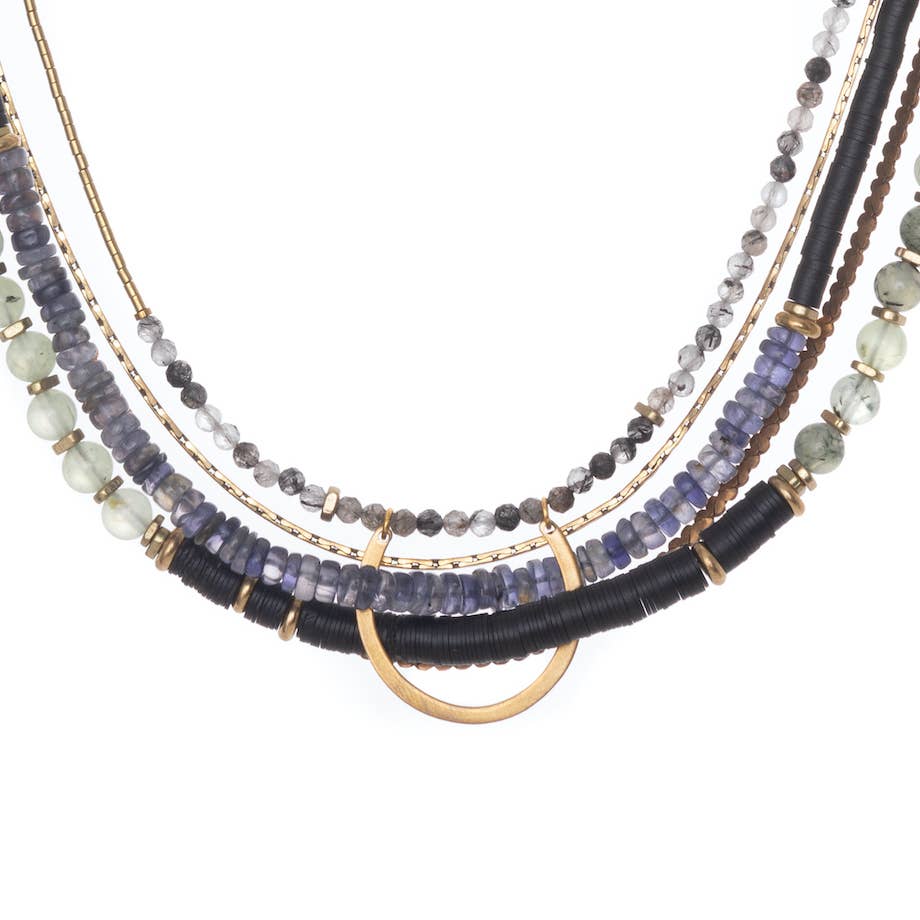 Hermona Necklace and its multicoloured palette of Prehnite, Iolite, Tourmilated Quartz and black fair-trade vinyl, folded through a vintage brass horseshoe pendant and accented with vintage brass chains