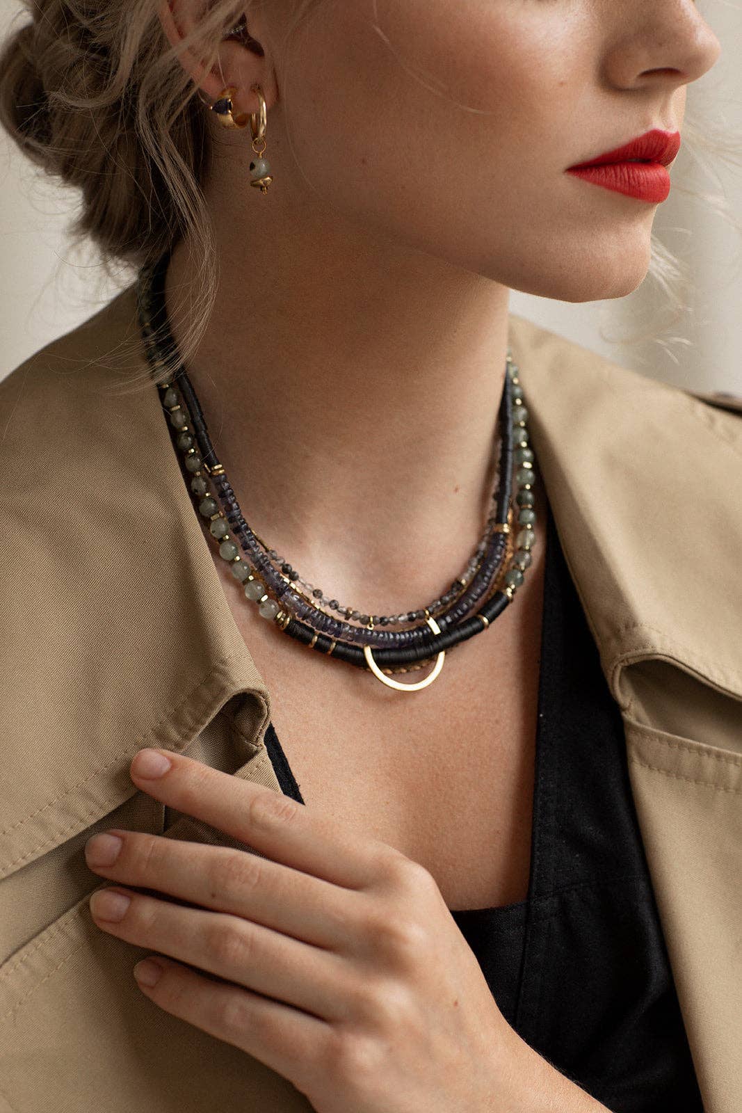 Hermona Necklace and its multicoloured palette of Prehnite, Iolite, Tourmilated Quartz and black fair-trade vinyl, folded through a vintage brass horseshoe pendant and accented with vintage brass chains | on model