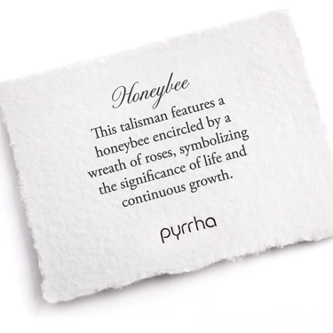 A Pyrrha Note describing the Honeybee Talisman. It reads, "This talisman features a honeybee encircled by a wreath of roses, symbolizing the significance of life and continuous growth."