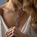Sterling Silver Necklace With a violet background under a talisman depicting a horse ON MODEL