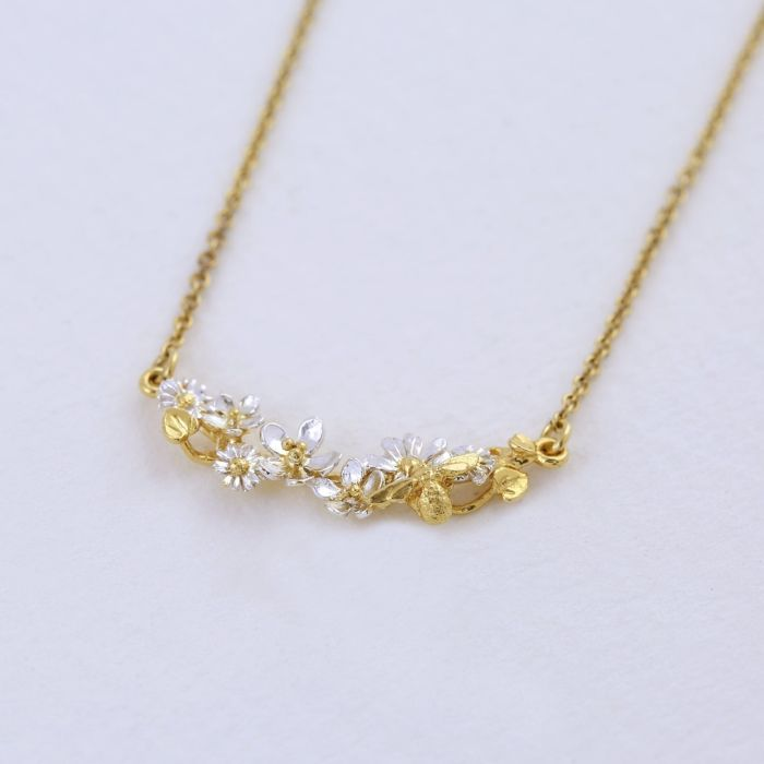 Gold Plated Silver In Line necklace with gold flowers with white petals