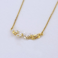 Gold Plated Silver In Line necklace with gold flowers with white petals