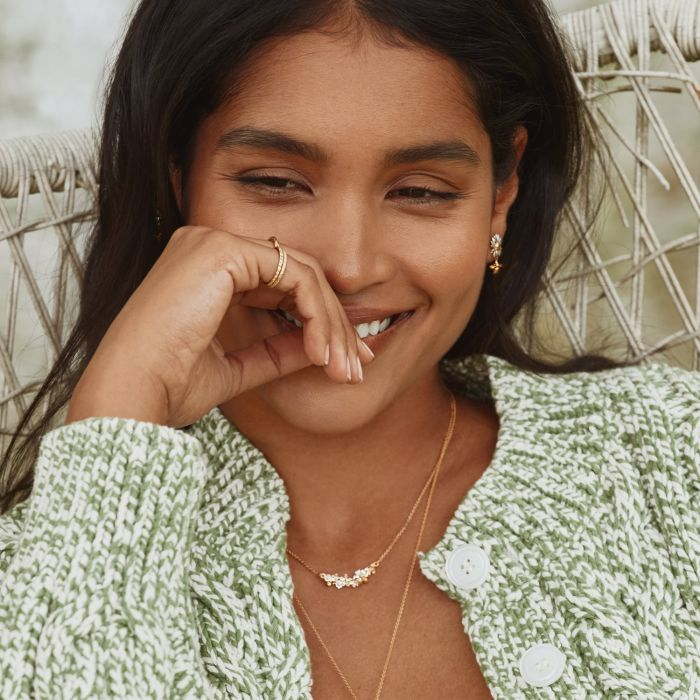 Gold Plated Silver In Line necklace with gold flowers with white petals | On Model