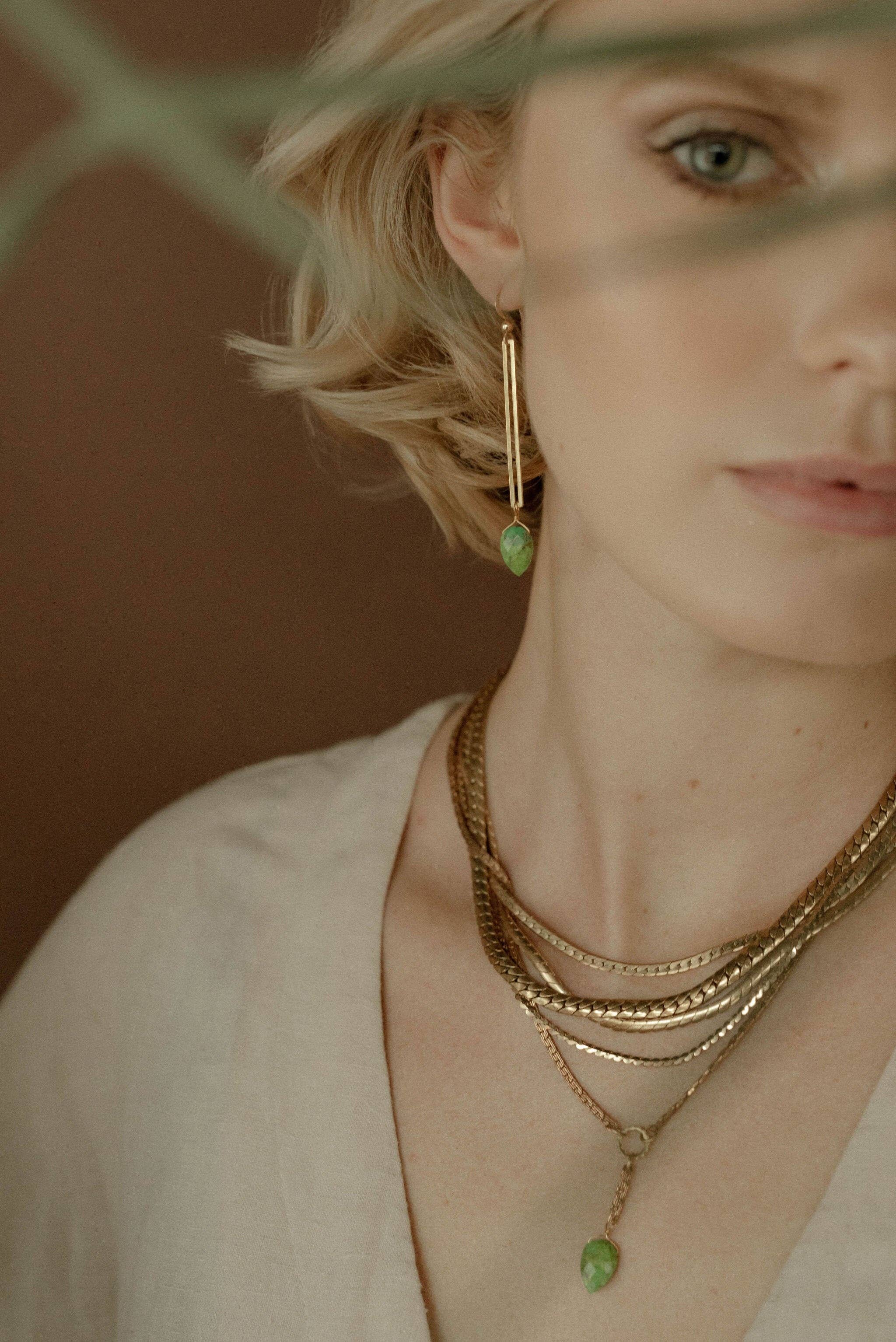 Recycled brass rectangle frames are accented with hand-cut gemstones to create the Isla Earrings.  | on model