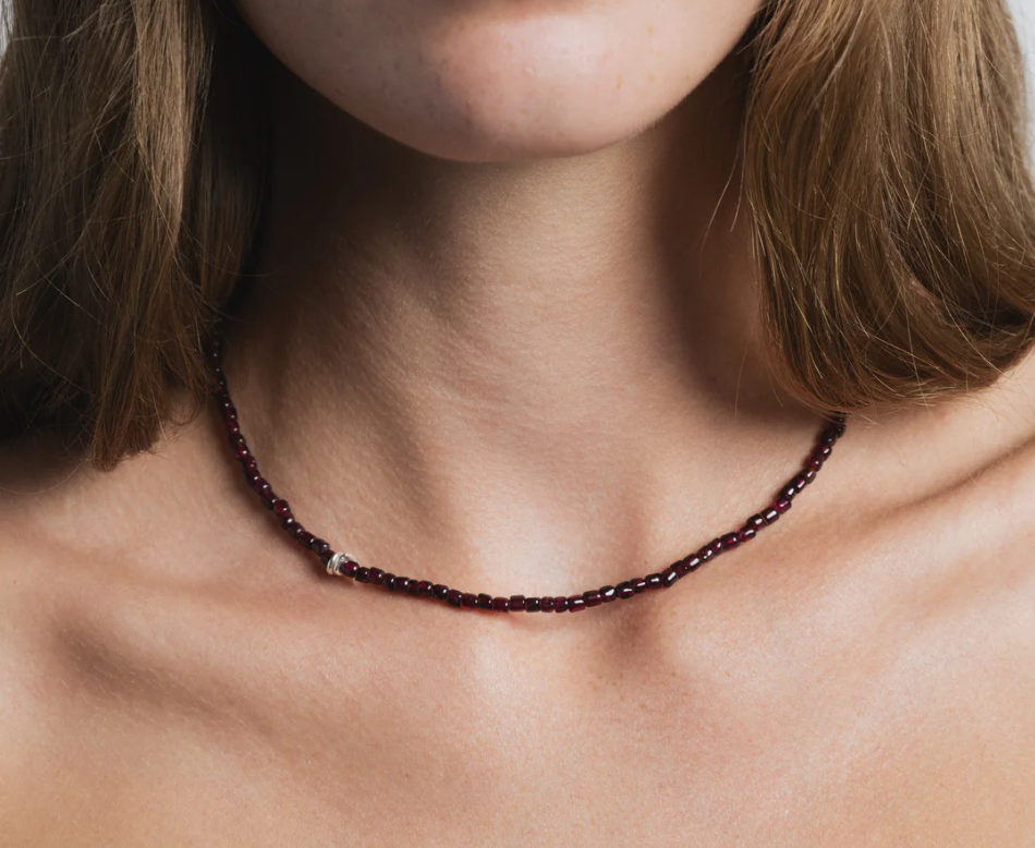 Small red garnet beaded necklace with a sterling silver lobster clasp | on model