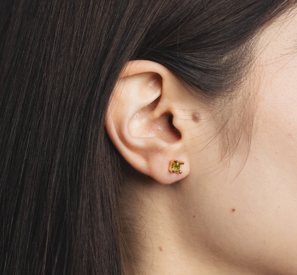 14k Gold plated brass studs with genuine peridot gemstones and gold vermeil posts | on model