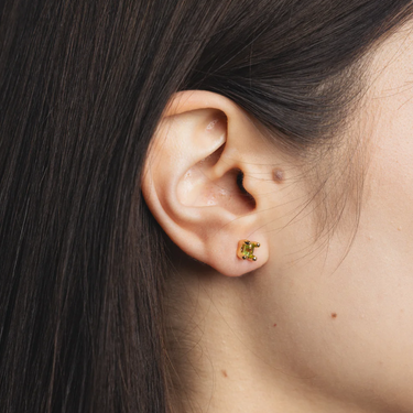 14k Gold plated brass studs with genuine peridot gemstones and gold vermeil posts | on model