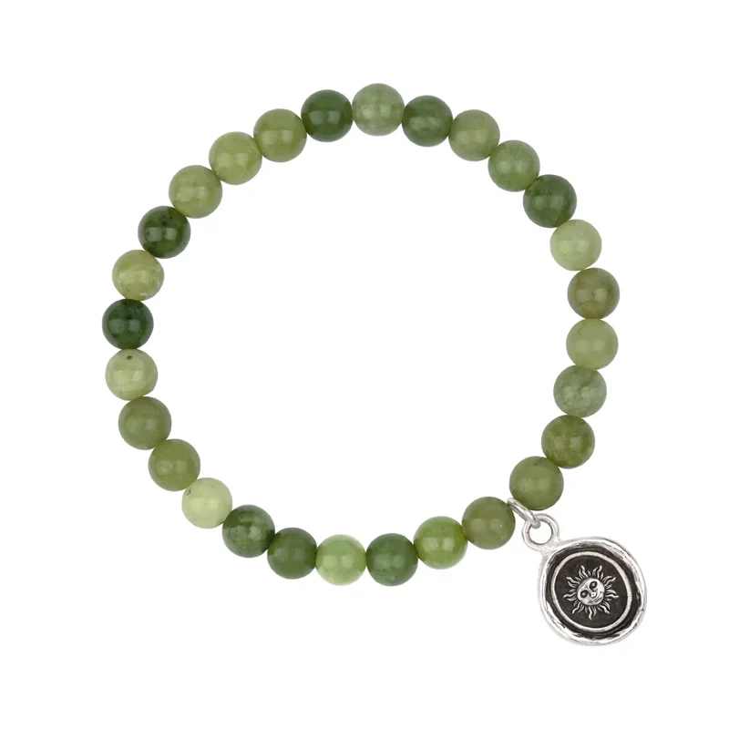 Bracelet made from Green Jade beads, with a Sterling Silver Talisman depicting The sun with a face on it