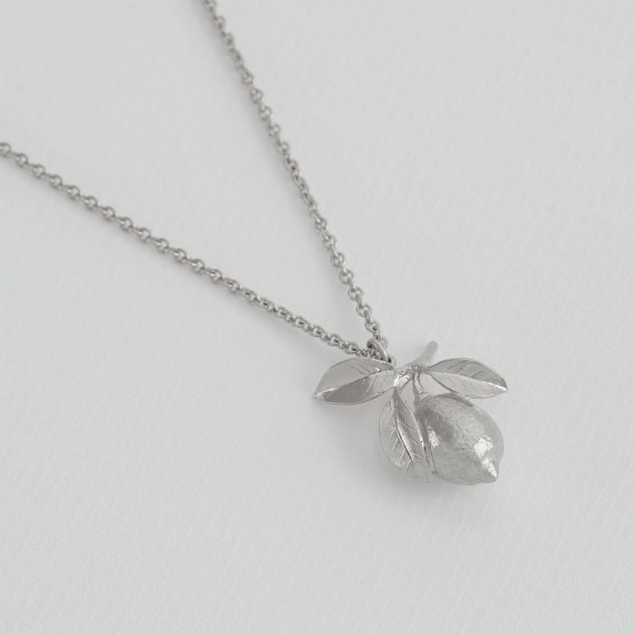 Silver Necklace with a Lemon Covered in leaves