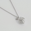 Silver Necklace with a Lemon Covered in leaves