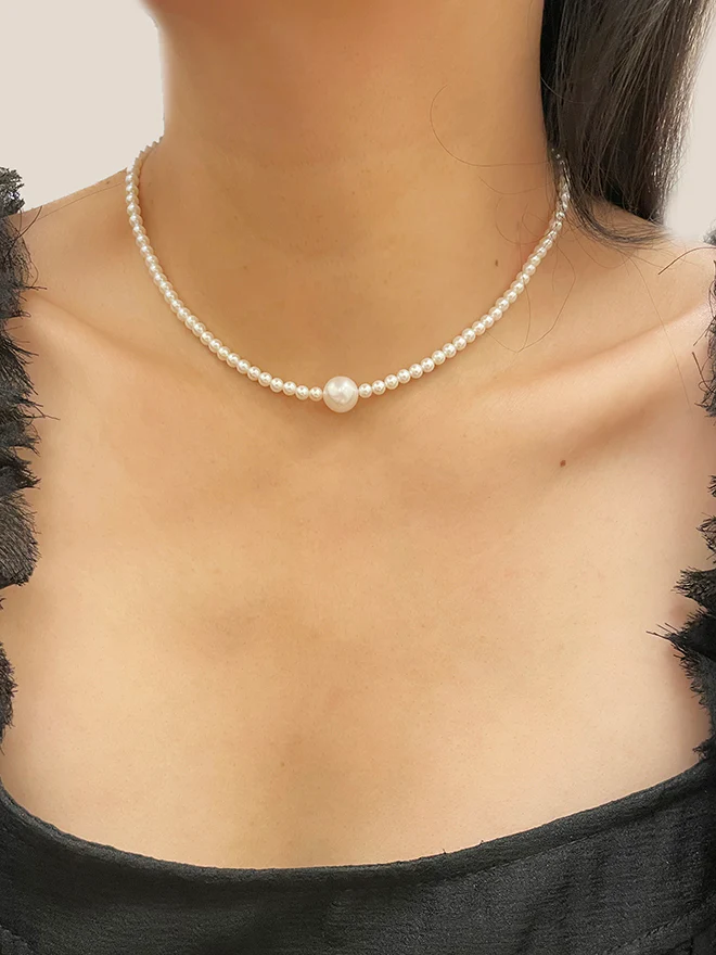 Freshwater Pearl Necklace with 3.5mm pearls on the Base chain, centered with a 8.5mm Pearl at the Base | On Model