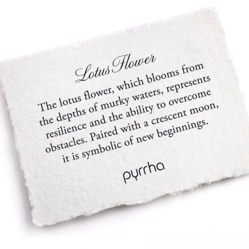 a Pyrrha note describing the lotus flower talisman. It reads, " The lotus flower, which blooms from the depths of murky waters, represents resilience and the ability to overcome obstacles. Paired with a crescent moon, it is symbolic of new beginnings."
