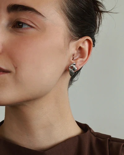 Silver floral stud earrings in pewter | on model