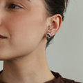 Silver floral stud earrings in pewter | on model