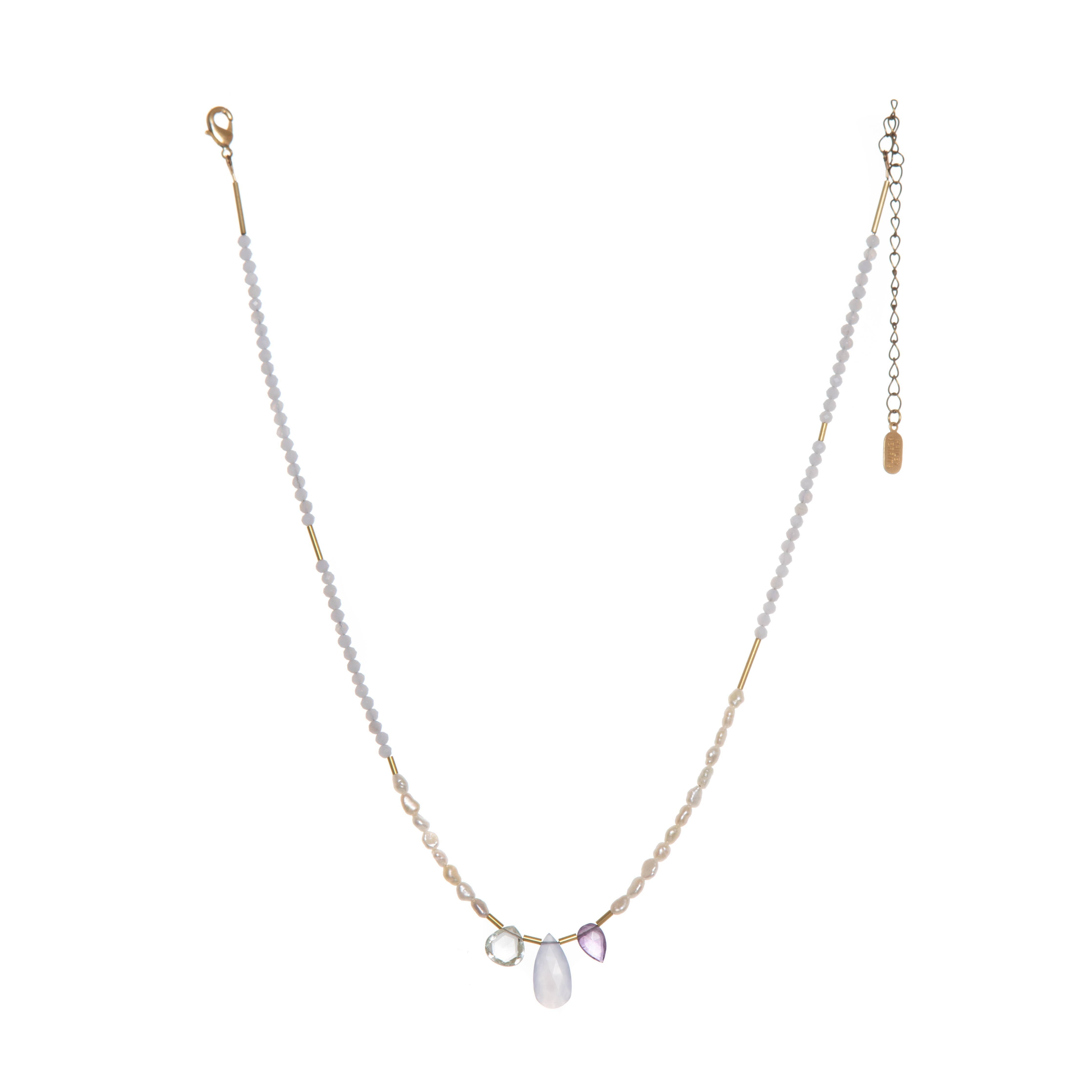 The Makani Necklace boasts hand-cut gemstones and stunning Freshwater Pearls with recycled brass accents asymmetrically spaced throughout. 