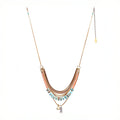Mariner Necklace, Featuring hand-cut strands of Turquoise and Dyed Coral gemstones with electroplated gold Hematite and paired withvintage brass chains and accented Hill-tribe sterling silver fish charm and 14K gold-plated brass coin charm