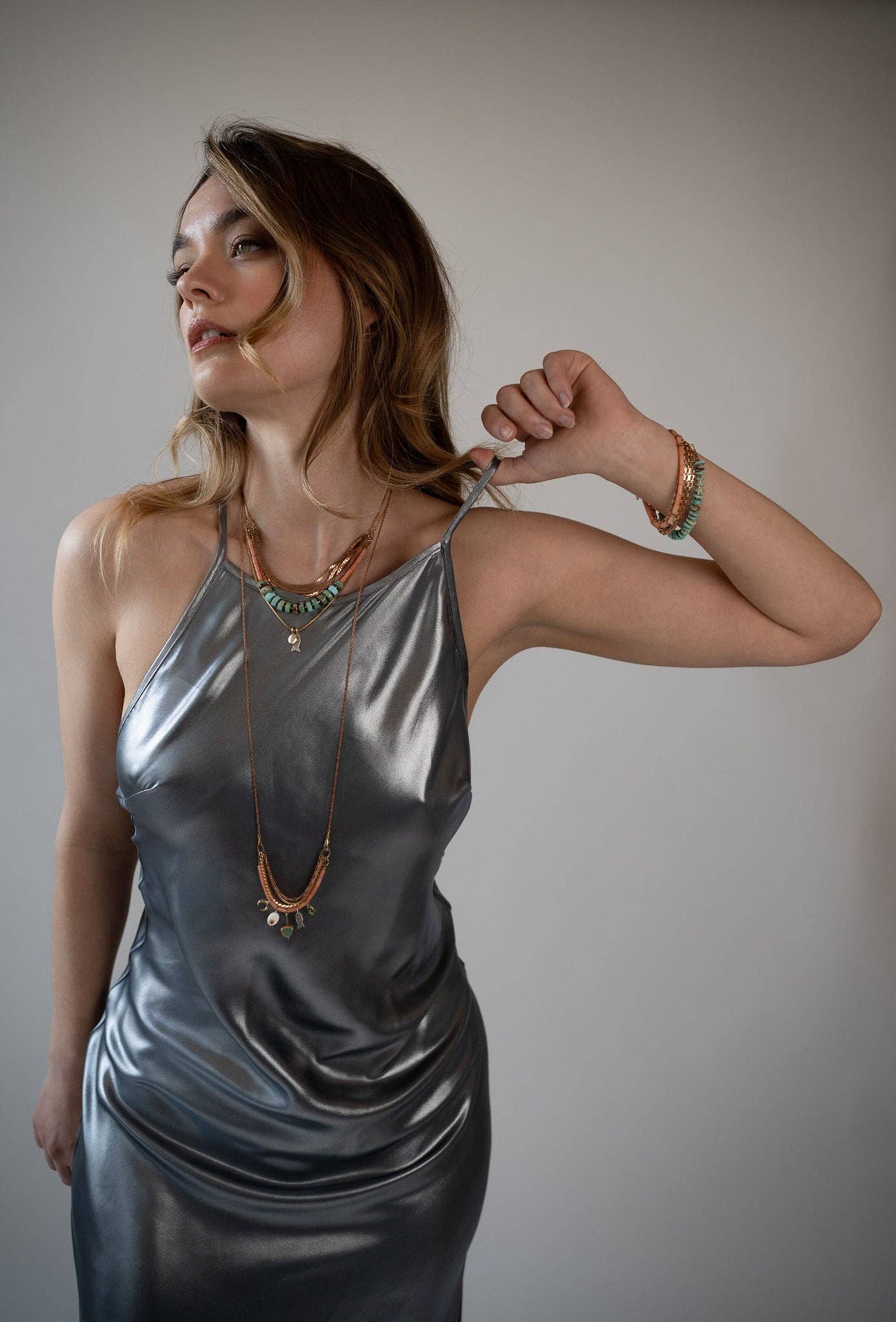 Mariner Necklace, Featuring hand-cut strands of Turquoise and Dyed Coral gemstones with electroplated gold Hematite and paired withvintage brass chains and accented Hill-tribe sterling silver fish charm and 14K gold-plated brass coin charm | on model