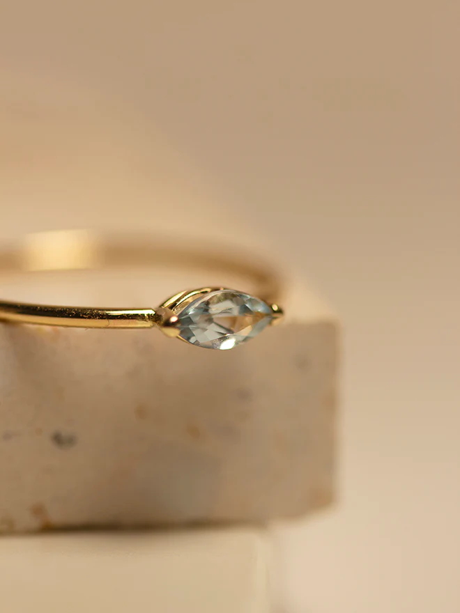 14k Yellow Gold Ring featuring a sleek marquise aquamarine gemstone