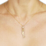 14k gold mermaid statue holding a round aquamarine necklace, on an 18″ gold wheat chain. | on model