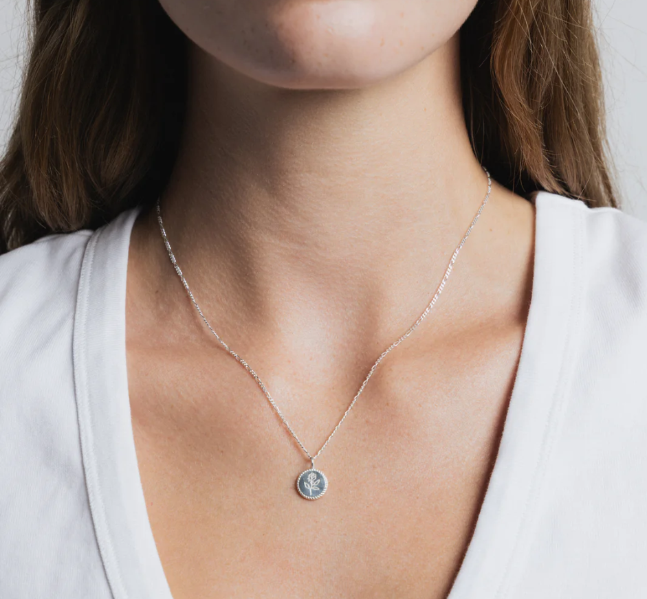 Sterling Silver Coin necklace with rose engraving on a Sterling silver figaro chain | on model