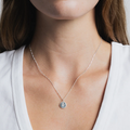 Sterling Silver Coin necklace with rose engraving on a Sterling silver figaro chain | on model