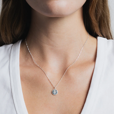 Sterling Silver Coin necklace with rose engraving on a Sterling silver figaro chain | on model