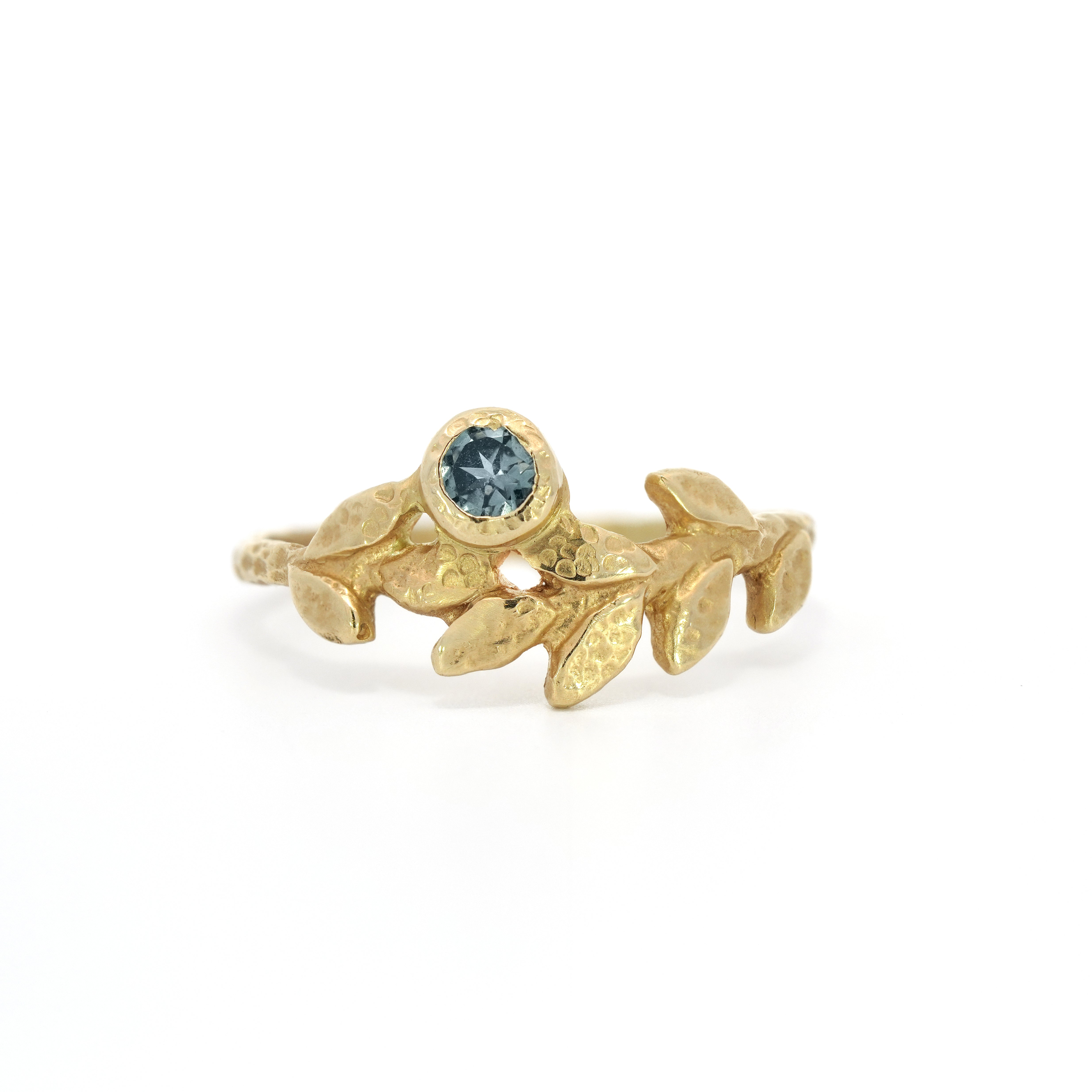 Wreath ring, accented with a luminous Montana Blue Sapphire