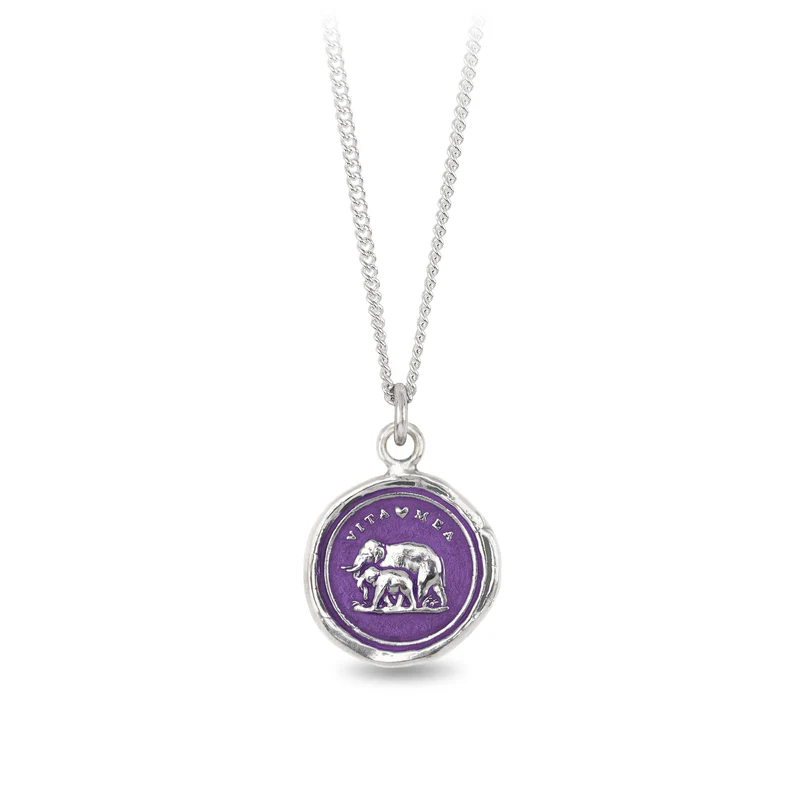 Sterling Silver necklace with a violet background under a talisman depicting 2 elephants, one an adult and one a child, and the text  'Vita Mea' above it.