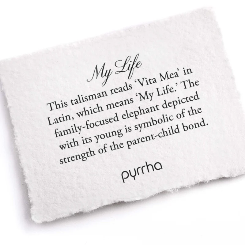 A Pyrrha note describing the My Life talisman. It reads, "This talisman reads 'Vita Mea' in Latin, which means 'My Life.' The family-focused elephant depicted with its young is symbolic of the strength of the parent-child bond."