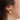 Short two-tone earrings adorned with a pewter stud and pendant | on model