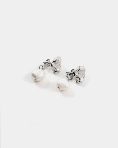 Silver pewter petal-shaped stud earrings with a freshwater pearl suspended behind the lobe
