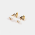 Gold pewter petal-shaped stud earrings with a freshwater pearl suspended behind the lobe