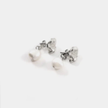Silver pewter petal-shaped stud earrings with a freshwater pearl suspended behind the lobe