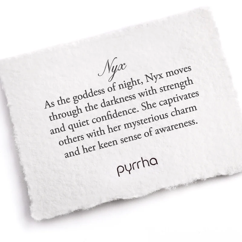 A Pyrrha note describing the Nyx talisman. It reads, "As the goddess of night, Nyx moves through the darkness with strength and quiet confidence. She captivates others with her mysterious charm and her keen sense of awareness."