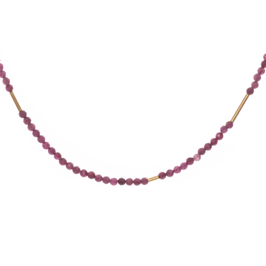 The Oso Necklace features hand-cut gemstones and recycled brass bars of varied lengths