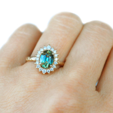14k yellow gold ring, featuring an oval teal sapphire, 1.63ct | on model