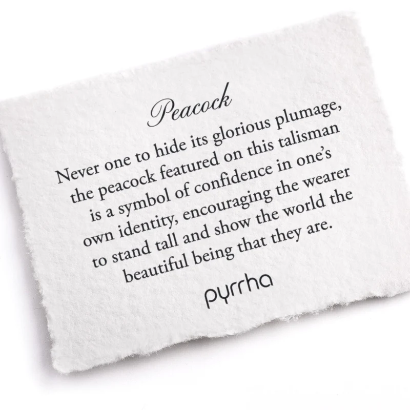 A Pyrrha note describing the Peacock talisman. It reads, "Never one to hide its glorious plumage, the peacock featured on this talisman is a symbol of confidence in one's own identity, encouraging the wearer to stand tall and show the world the beautiful being that they are."