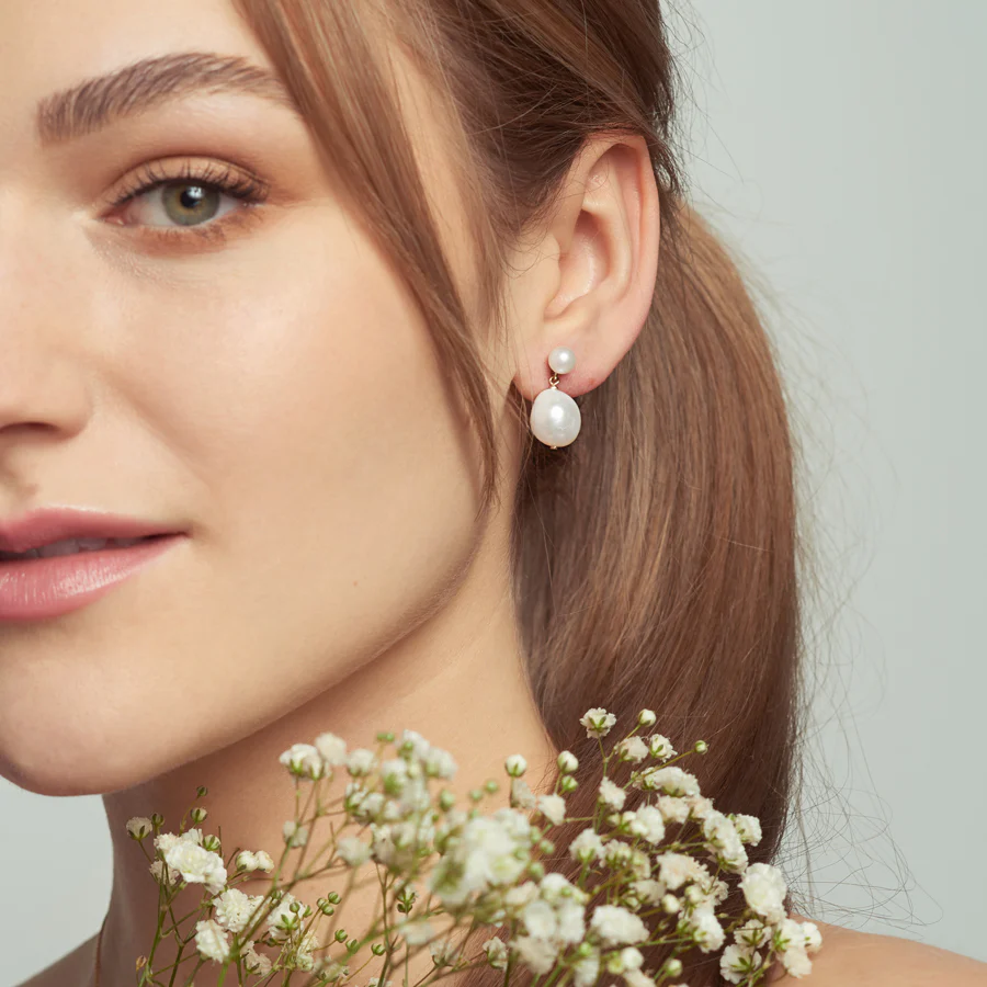 Pearl Earrings with A small round pearl combines with an organically shaped oval pearl | On model