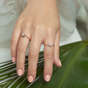 14k Yellow gold Ring featuring A cluster of diamonds adorning a white pearl in the center | on model