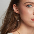 14k Yellow Gold Earrings withTiny oval pearls joined by a delicate solid gold chain | on model