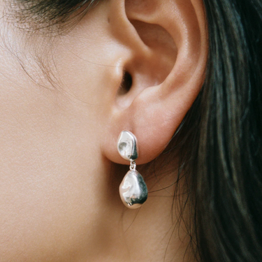 Sterling Silver Bean shaped dangle statement earring with sterling silver ear posts | on model