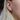 Lilac purple oval cut sapphire earrings accented by a tiny colourless round cut sapphire in solid 14k Yellow Gold.  | on model