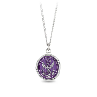 Sterling SIlver talisman necklace with a bright purple background depicting a phoenix Rising up from a bed of flames