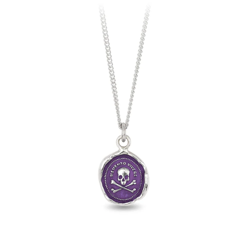 Sterling Silver necklace with a violet background under a talisman depicting a skull and crossbones symbol, with the text "memento vivere" written above it